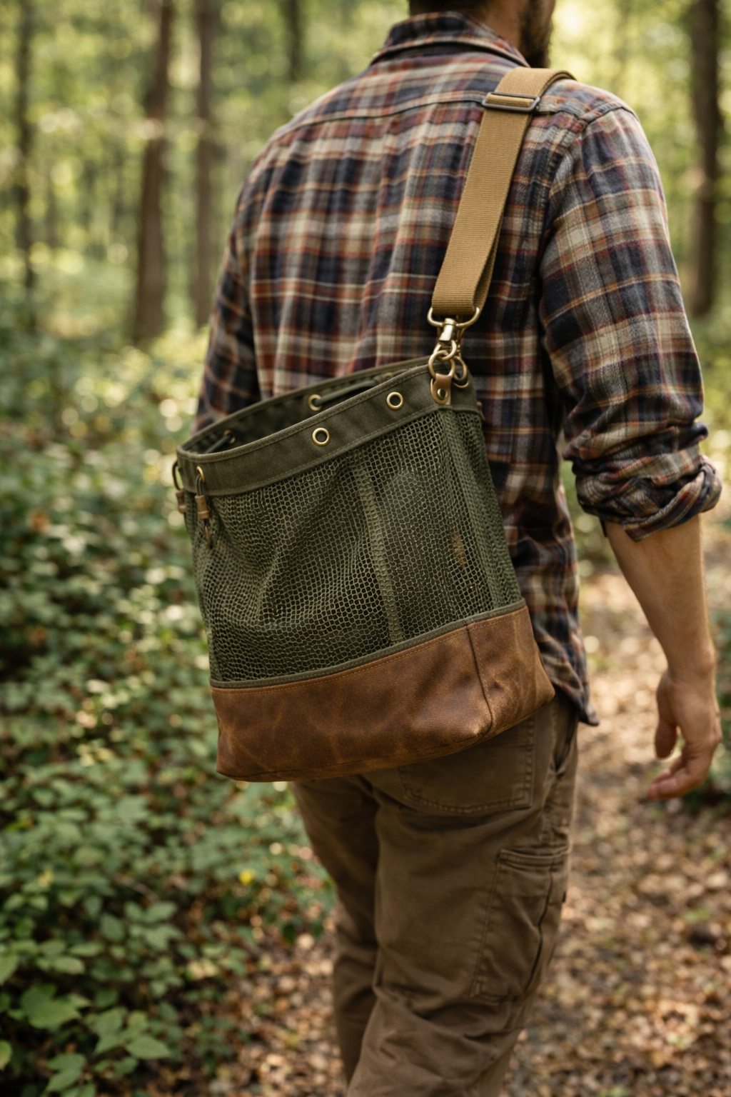 Person wearing a green and brown foraging bag in a forest setting